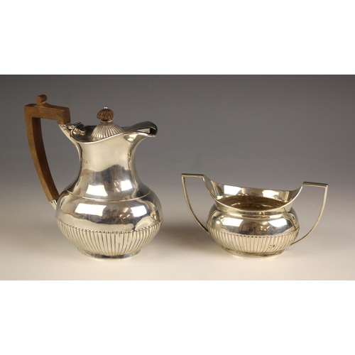 94 - A George V silver bachelors hot water jug, Goldsmiths and Silversmiths Co Ltd, London 1933, the flar... 