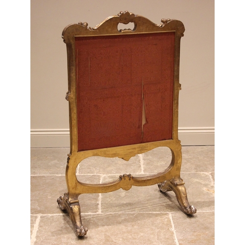 986 - A 19th century French giltwood and gesso Rococo fire screen, the swept frame with a 'C' scroll apert... 