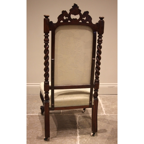 988 - A Victorian carved walnut bedroom chair, the 'C' scroll open work crest above a padded back and barl... 