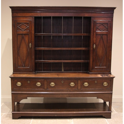 990 - A George III and later oak and mahogany crossbanded Montgomery dresser, the high back with a moulded... 