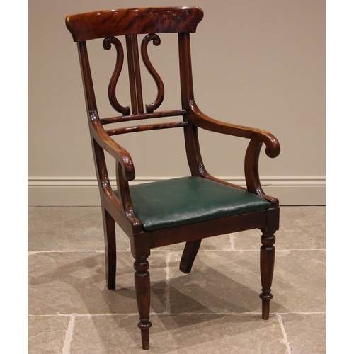 999 - A Victorian mahogany desk chair, the concave top rail upon lyre shaped uprights, over the padded dro... 