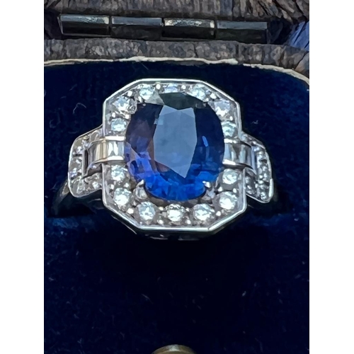 330 - An Art Deco style sapphire and diamond cluster ring, the central oval cut sapphire within octagonal ... 