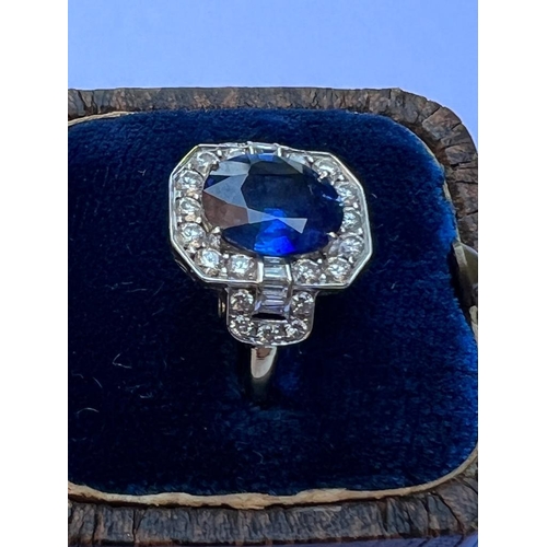 330 - An Art Deco style sapphire and diamond cluster ring, the central oval cut sapphire within octagonal ... 