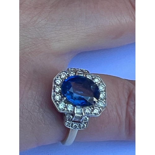 330 - An Art Deco style sapphire and diamond cluster ring, the central oval cut sapphire within octagonal ... 