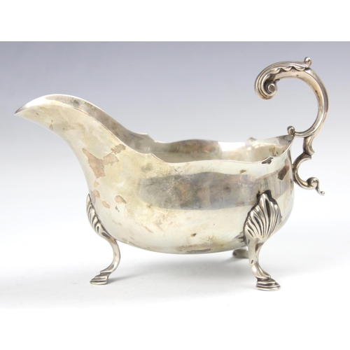 89 - An Edwardian silver sauce boat, Henry Atkin, Sheffield 1902, the acanthus leaf capped flying handle ... 