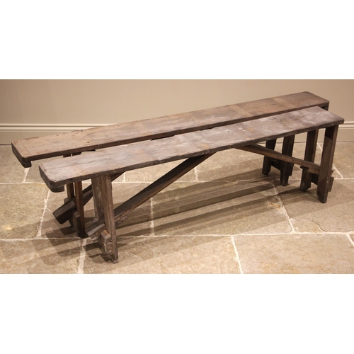 1021 - A near pair of pine benches, early 20th century, of rectangular form upon trestle type supports, 52c... 