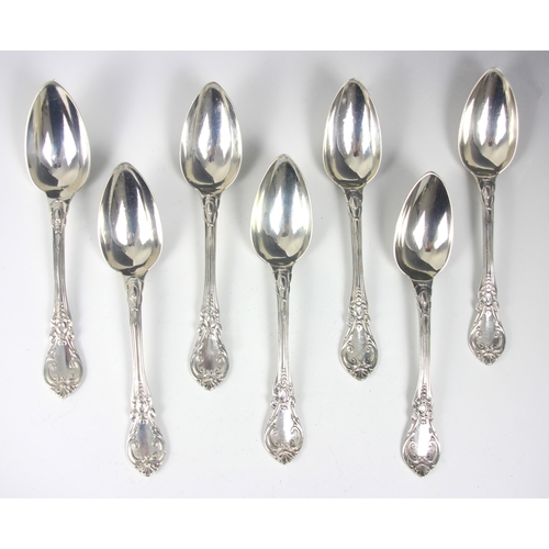 82 - A set of sixteen 19th century French silver dessert spoons, the scrolling decorated spoon with initi... 