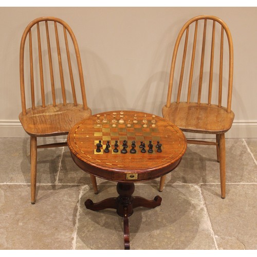 1065 - A brass inlaid hardwood pedestal chess table, late 20th century, the circular moulded top inlaid wit... 