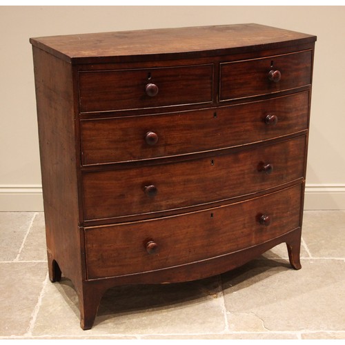 989 - A mahogany bow front chest of drawers, early 19th century, formed with two short over three long oak... 