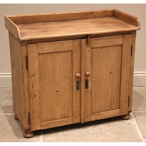 991 - A Victorian pine tray top cupboard, the rectangular top with a three quarter gallery, over a pair of... 