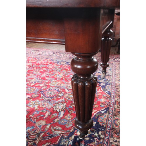 1005 - Victorian mahogany extending dining table, with three additional leaves, the rectangular moulded top... 