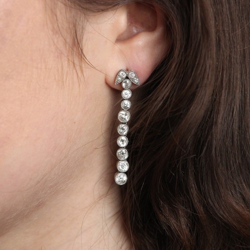 321 - A pair of 20th century style diamond drop earrings, the earrings designed as nine old cut diamonds i... 