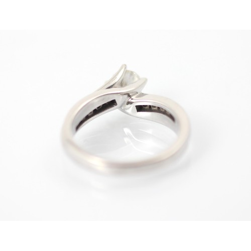 227A - A late 20th century diamond solitaire ring, the round cut diamond in white metal claw setting with s... 