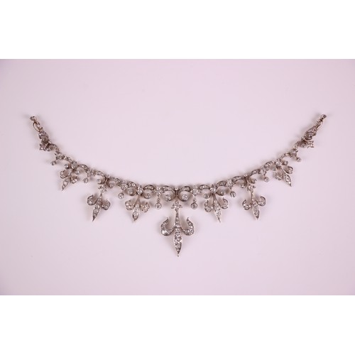 245 - A late 19th/early 20th century diamond set tiara converting to necklace, the central fleur-de-lys mo... 