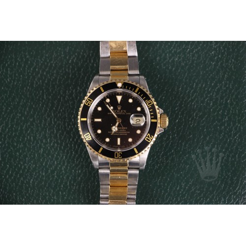 199 - A Rolex Submariner Oyster perpetual date bi-colour wristwatch, the circular black dial with baton an... 