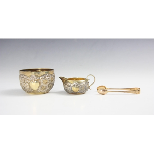 1 - An Edwardian cased silver gilt sugar bowl, cream jug and tea tong, Robert Stebbings, London 1903-190... 