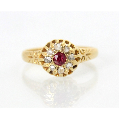 104 - An early 20th century 18ct diamond and untested ruby cluster ring, the round cut red stone within a ... 
