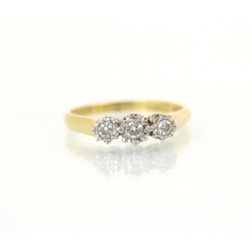 112 - An 18ct yellow gold three stone diamond ring, the central round cut diamond with smaller diamond to ... 