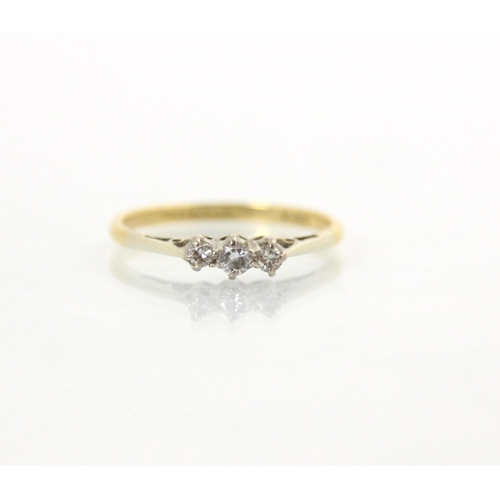118 - An Edwardian style three stone diamond ring, the central round cut diamond with smaller diamond to e... 