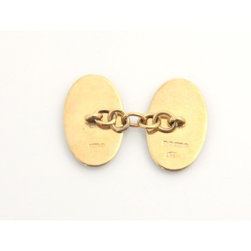 119 - A pair of 9ct yellow gold cufflinks, the oval links with engine turned detail to one side, stamped ‘... 