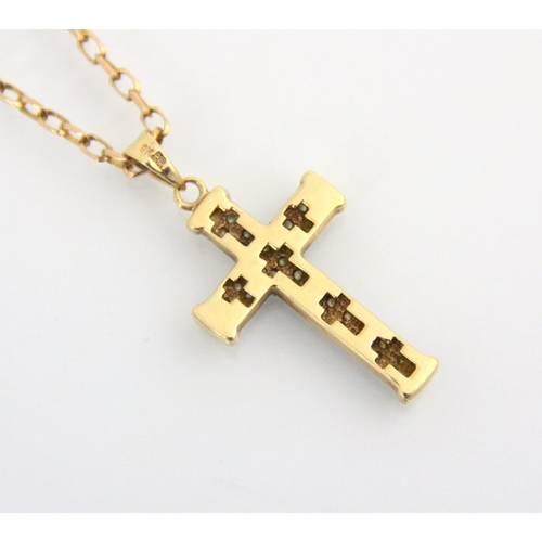 127 - A 9ct yellow gold diamond set cross pendant, the thirty two round cut diamonds set within white claw... 