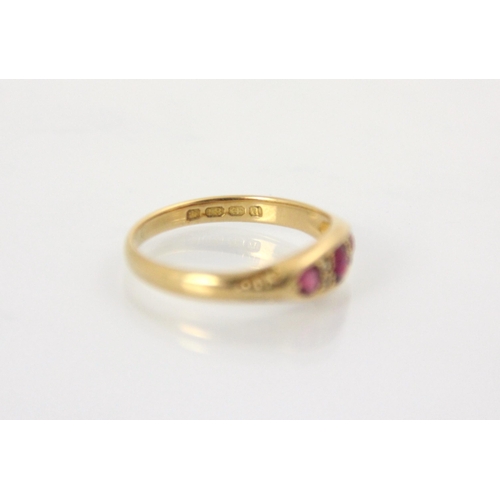 132 - An Edwardian untested ruby and diamond ring, the central  cushion cut red stone with a smaller round... 