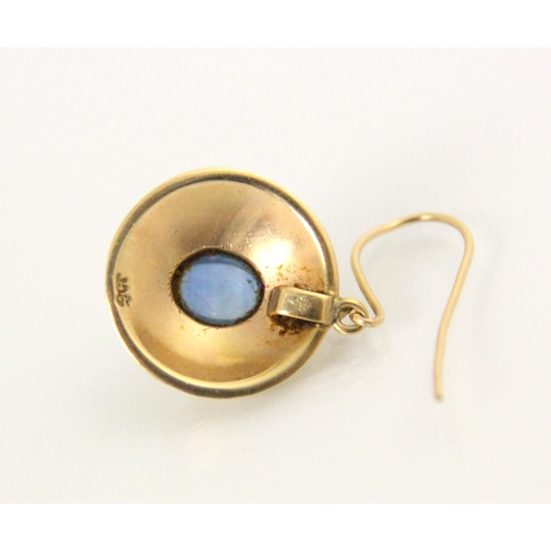 133 - A pair of yellow metal and untested sapphire earrings, the central oval cabochon within a yellow gol... 