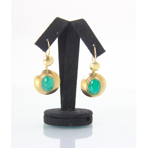 137A - A pair of yellow metal and untested emerald earrings, the circular discs with central oval cut caboc... 