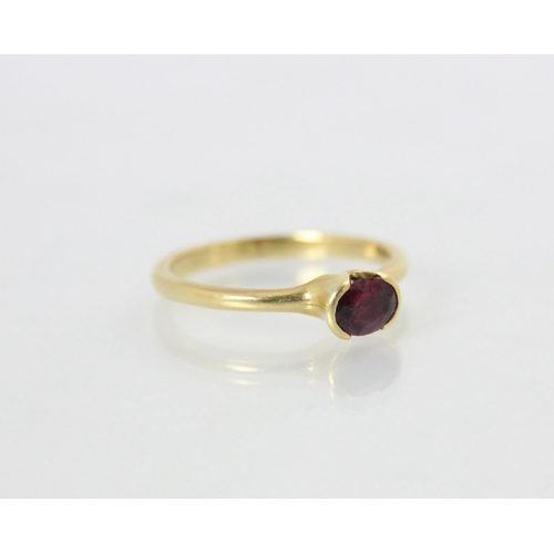 148 - A bespoke 18ct yellow gold untested ruby solitaire ring, the oval cut stone within a cut out raised ... 