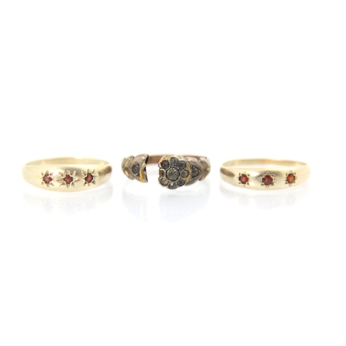 160 - A 9ct yellow gold red stone ring, the three red stones within star cut designed head, stamped 'CJ' B... 