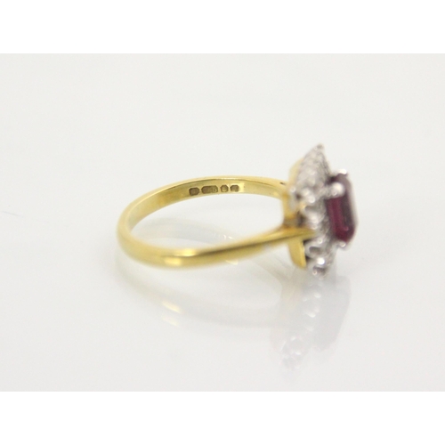 163 - An 18ct yellow gold untested almandine garnet and diamond cluster ring, the emerald cut red stone wi... 