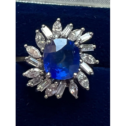 166 - A 1960's sapphire and diamond cluster ring, the central cushion cut sapphire within white metal claw... 