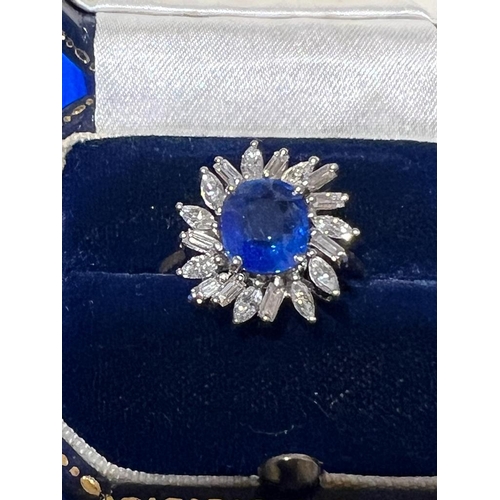 166 - A 1960's sapphire and diamond cluster ring, the central cushion cut sapphire within white metal claw... 