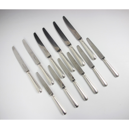 23 - A set of six silver handled feather edge pattern table knives, Garrard and Co, London 1961-62, the h... 