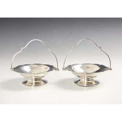 26 - A pair of Edwardian silver bonbon dishes, R H Halford & Sons, London 1908, the shaped swing handle a... 