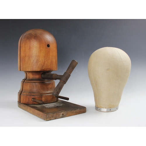 350 - An Edwardian turned mahogany milliners hat block or stretcher, circa 1910, with a linen covered mill... 
