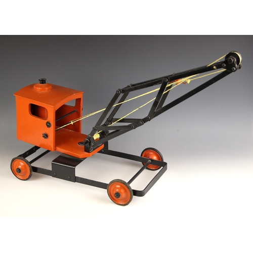 479 - A wood and steel toy crane, probably mid 20th century, the pivoting wooden cab painted orange, the s... 