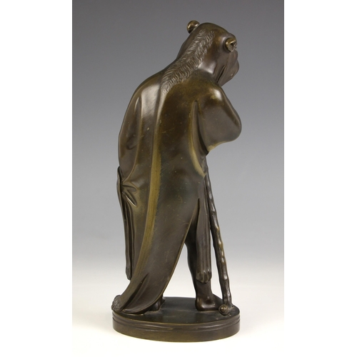 518 - A bronze of a cloaked figure, 19th century, modelled standing wearing an animal hide hooded cloak, w... 