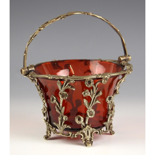 619 - A white metal mounted ruby glass sugar basket, 19th century, the pierced gallery designed as springs... 