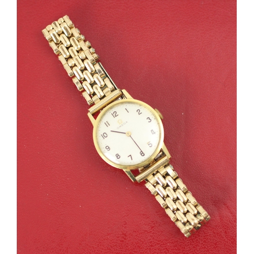 66 - A yellow metal Omega wristwatch, the circular cream dial with Arabic numerals, set to plain polished... 