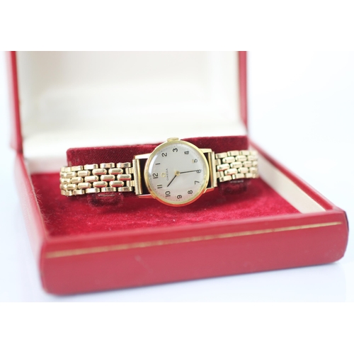 66 - A yellow metal Omega wristwatch, the circular cream dial with Arabic numerals, set to plain polished... 