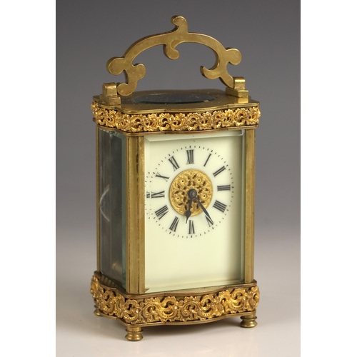 730 - A French eight day brass cased carriage timepiece, late 19th century, the case of serpentine form ap... 