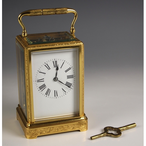 736 - A brass cased two train carriage clock, late 19th century, the profusely engraved case and bevelled ... 