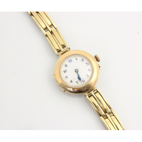 78 - A ladies 15ct wristwatch, the circular white dial with Arabic numerals and gilt dotted highlights, s... 