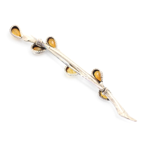 82 - A white metal and citrine brooch, the brooch designed as stylised sprig of pussy willow with six tea... 