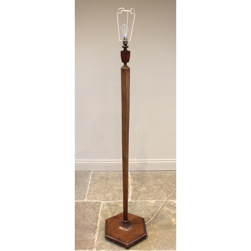 827 - An Art Deco walnut standard lamp, circa 1930, the urn and hexagonal tapering column extending to a s... 