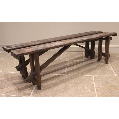 829 - A near pair of pine benches, early 20th century, of rectangular form upon fixed trestle type support... 