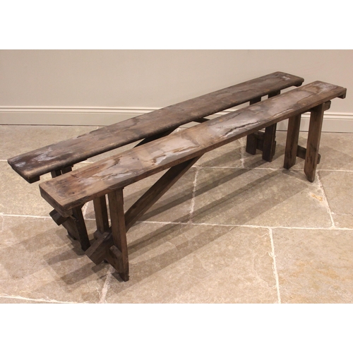 829 - A near pair of pine benches, early 20th century, of rectangular form upon fixed trestle type support... 