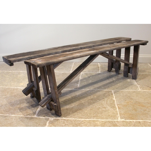 830 - A near pair of pine benches, early 20th century, of rectangular form upon fixed trestle type support... 