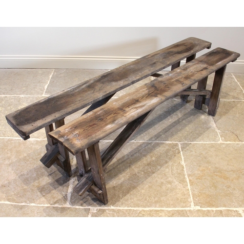 830 - A near pair of pine benches, early 20th century, of rectangular form upon fixed trestle type support... 